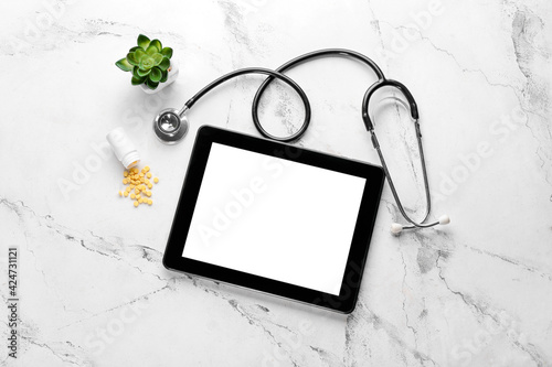 Stethoscope, bottle with fo...