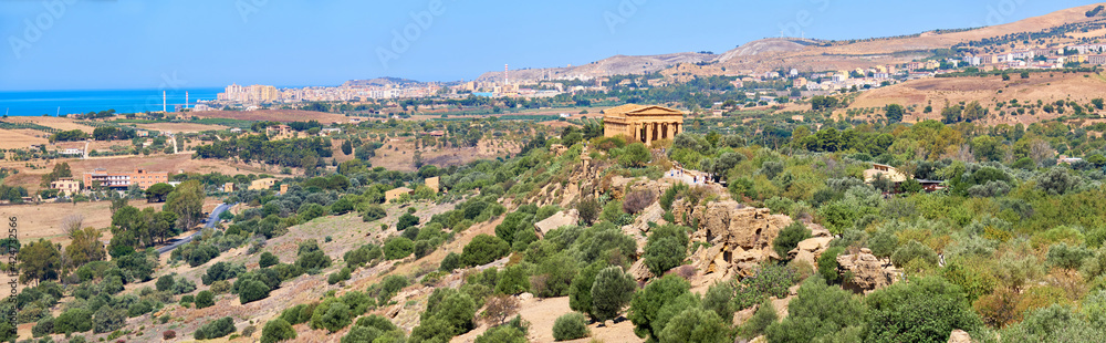 Aerial bird view, Valley of of Temples, Agrigento, Sicily, Italy, with Temple of Concordia in the middle. Summer sunny day, blue sky, panoramic banner image.