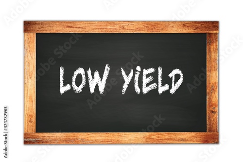 LOW YIELD text written on wooden frame school blackboard.