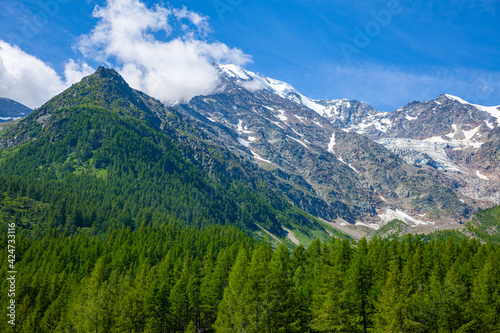 Scenic summer mountain landscape of Swiss Alps with rocky peaks and green hillsides. View from Simplon Pass.