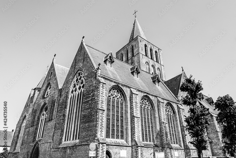 St. Giles’s Church in the robust Brick Gothic style in Bruges, Belgium in black and white