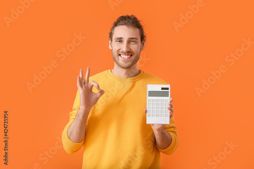 Young man with calculator s...