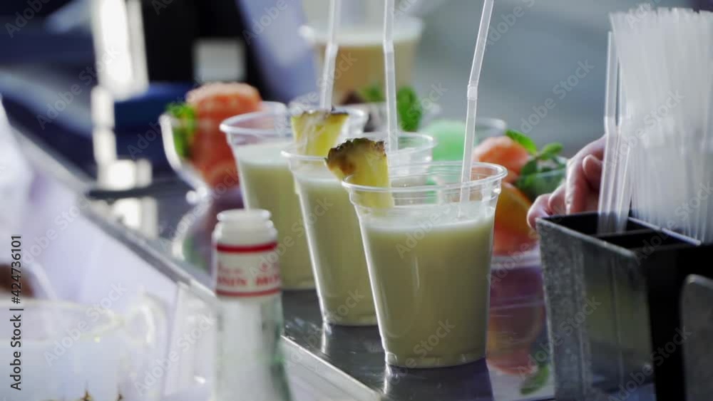 fruit smoothies cocktails are on the bar in plastic cups fruit smoothies cocktails are on the bar in plastic cups