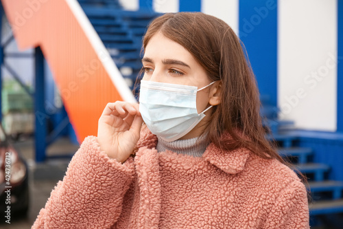 Young woman in medical mask...