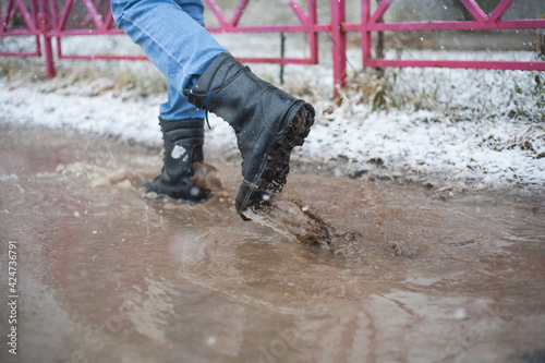 in army boots in puddles, black lace-up boots and wet weather, trekking shoes in the city