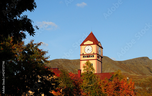 Kirovsk, Russia, September, 08, 2011. Museum and Exhibition Center of JSC Apatite in Kirovsk on a sunny autumn day. A tall building with a clock. Kirovsk city looks like Big Ben photo