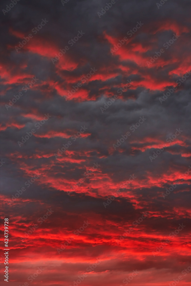 Sunset red sky with dark clouds. Beautiful sunset sky. Natural background. Without Filters. Dramatic sky. Natural cloud landscape