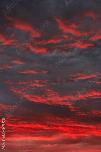 Sunset red sky with dark clouds. Beautiful sunset sky. Natural background. Without Filters. Dramatic sky. Natural cloud landscape
