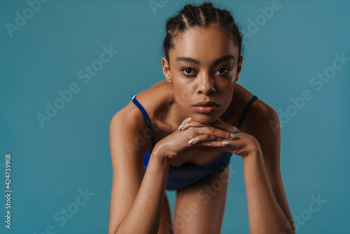 Young black swimmer looking at camera while warming up