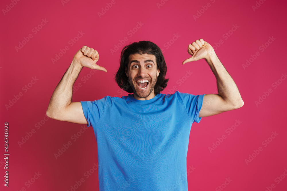 Unshaven excited man exclaiming and pointing finger at himself