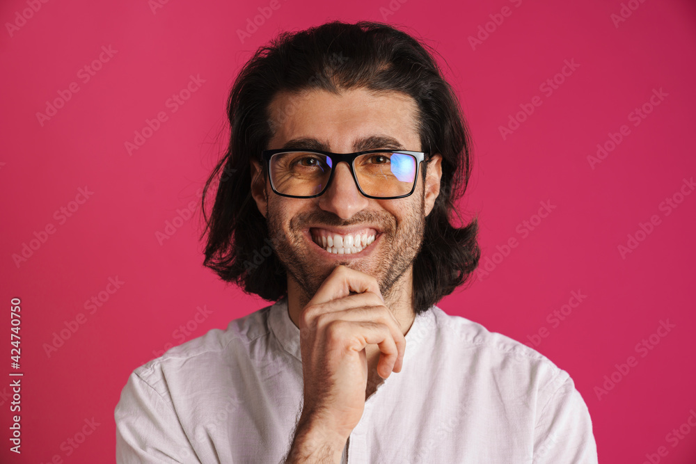 White brunette man in eyeglasses smiling and looking at camera White brunette man in eyeglasses smiling and looking at camera