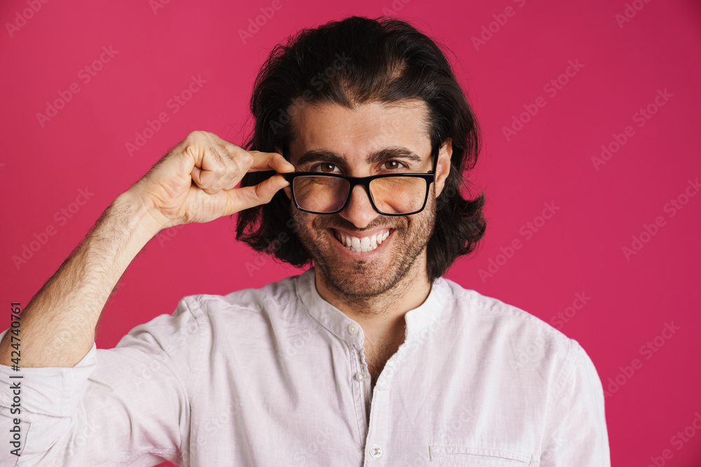 White brunette man in eyeglasses smiling and looking at camera White brunette man in eyeglasses smiling and looking at camera