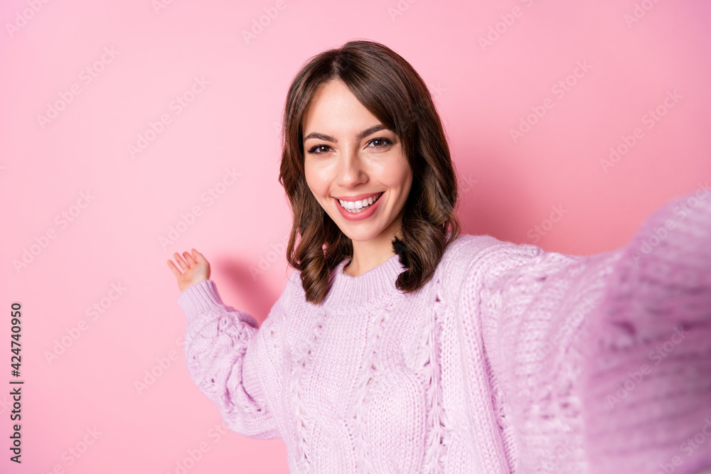 Photo of cheerful positive young girl hand show empty space wear knitted sweater isolated pink color background Photo of cheerful positive young girl hand show empty space wear knitted sweater isolated pink color background