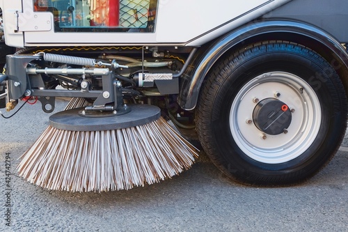 Sweeping equipment for routine year-round municipal street and highway sweeping.Big round brush of street sweeper with wide sweeping path close up.Urban street cleaning.All seasons cleaning machine © Matrix Reloaded
