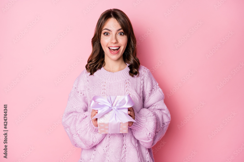 Portrait of lovely amazed cheerful girl holding in hands giftbox isolated over pink pastel blue color background Portrait of lovely amazed cheerful girl holding in hands giftbox isolated over pink pastel blue color background