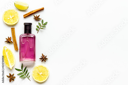 Flat lay of men perfume with flowers and citrus. Top view