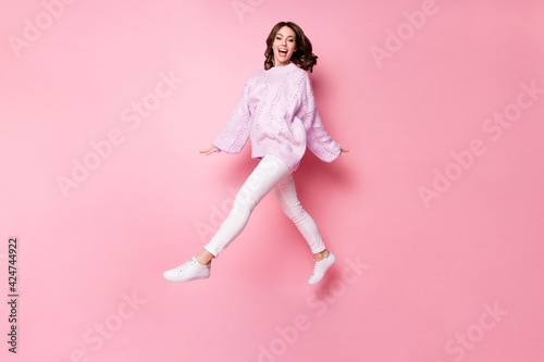 Full length body size of lovely cheerful girl jumping walking having fun isolated over pink pastel blue color background
