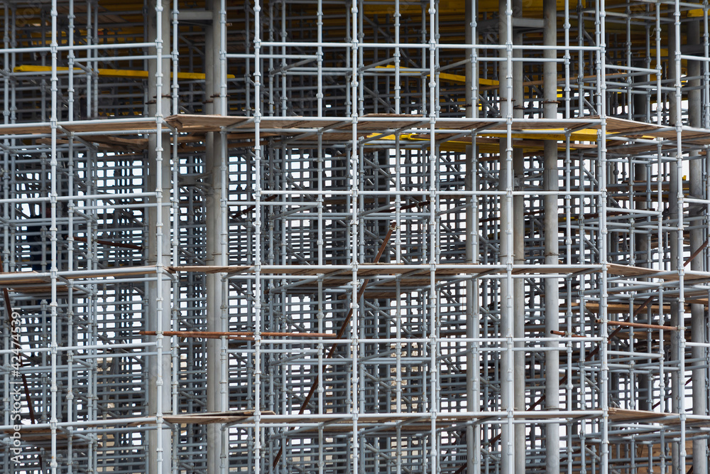 View of scaffolding and structural reinforcement during the construction of a round building.