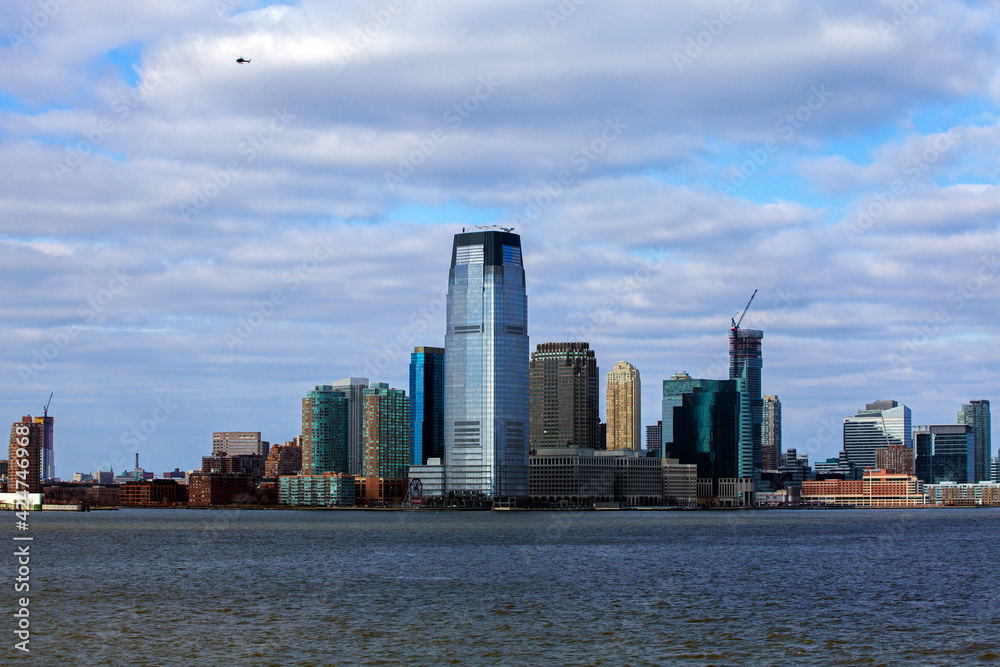 Obraz premium Office buildings and skyscrapers on the coastline of Lower Manhattan . cloudy day
