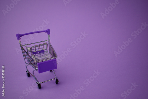 toy shopping baskets with small glass bubbles on a purple background. Shopping carts.