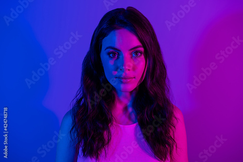 Photo of young happy lovely beautiful stunning elegant woman with messy hair isolated on neon blue color background