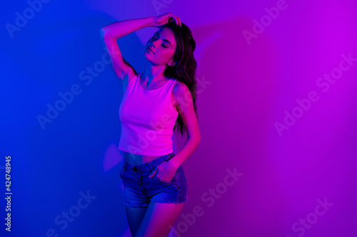 Photo of young stunning elegant gorgeous woman posing dreaming with closed eyes isolated on vibrant neon background