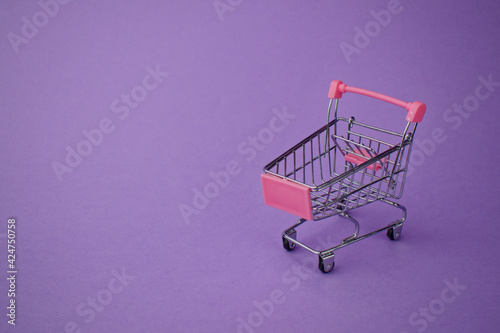 toy shopping baskets on a purple background. Shopping carts.