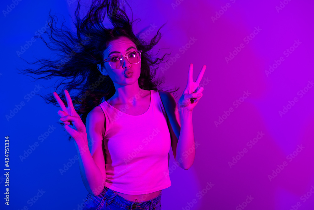 Photo of pretty person kiss lips look camera two arms fingers show v-sign isolated on gradient neon background