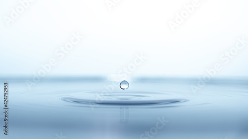 water drop splash in a glass blue colored photo