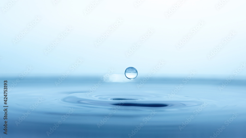 water drop splash in a glass blue colored water drop splash in a glass blue colored
