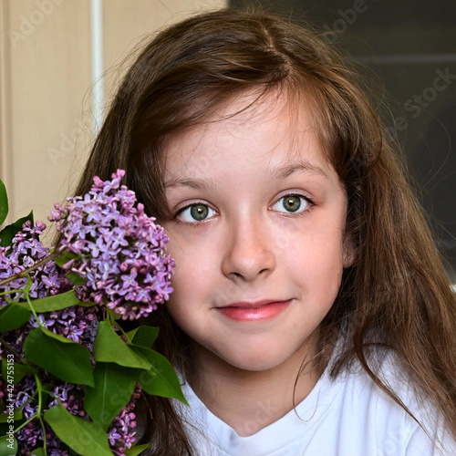 portrait of a teenage girl with lilac close up