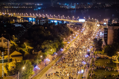 Aerial view of crowd of people walking along the street