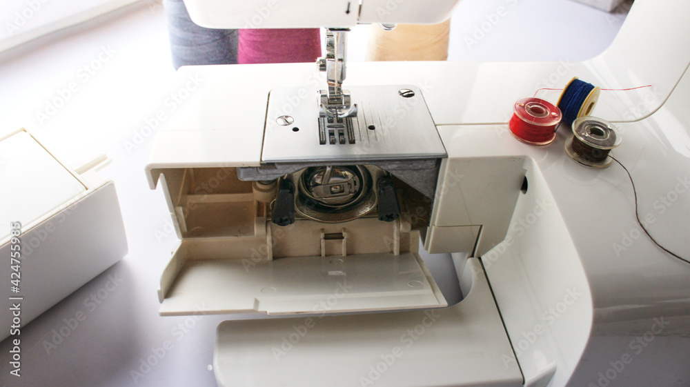 electric sewing machine with thread and bobbin
