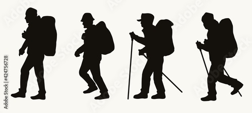 Silhouettes of male hikers with backpacks