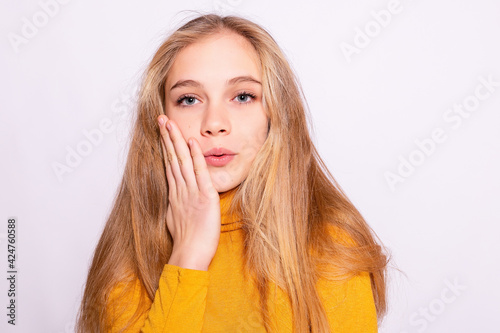 Trendy beautiful hipster girl. Photo of positive young nice woman in yellow knee-high with white background. surprised