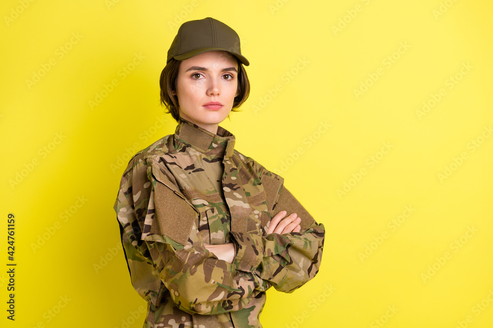 Profile photo of half turned serious girl folded hands look concentrated camera isolated on yellow color background Profile photo of half turned serious girl folded hands look concentrated camera isolated on yellow color background