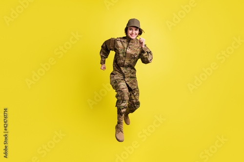 Full length photo of cheerful sportive girl rush toothy smile look camera isolated on yellow color background photo