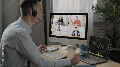 Wallpaper Mural Online conference, video call, business meeting. Successful adult businessman have conversation with multiracial business colleagues by video call using a computer while sitting at his workplace Torontodigital.ca