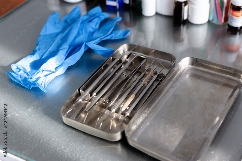 Dental instruments and medical gloves on the table Dental instruments and medical gloves on the table