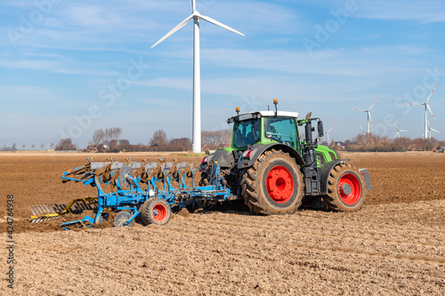 Agricultural technology | Tractor with mounted reversible plough in the field | 4929