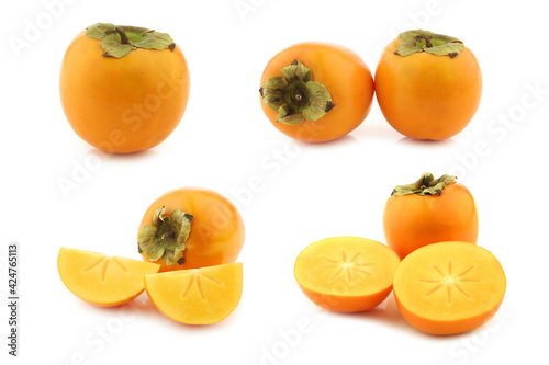 fresh kaki fruit and some cut pieces on a white background