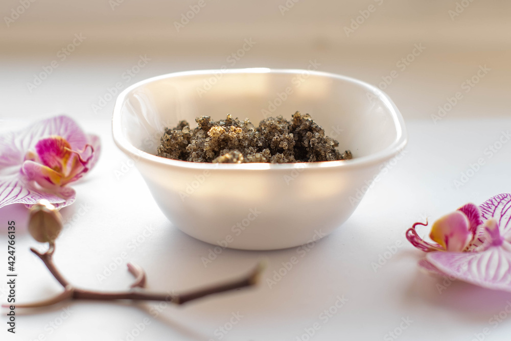 Plate of scrub wiht roses on white orcgids, top view. image of homemade cosmetics ingredients. aroma theme. organic cosmetics. Plate of scrub wiht roses on white orcgids, top view. image of homemade cosmetics ingredients. aroma theme. organic cosmetics.