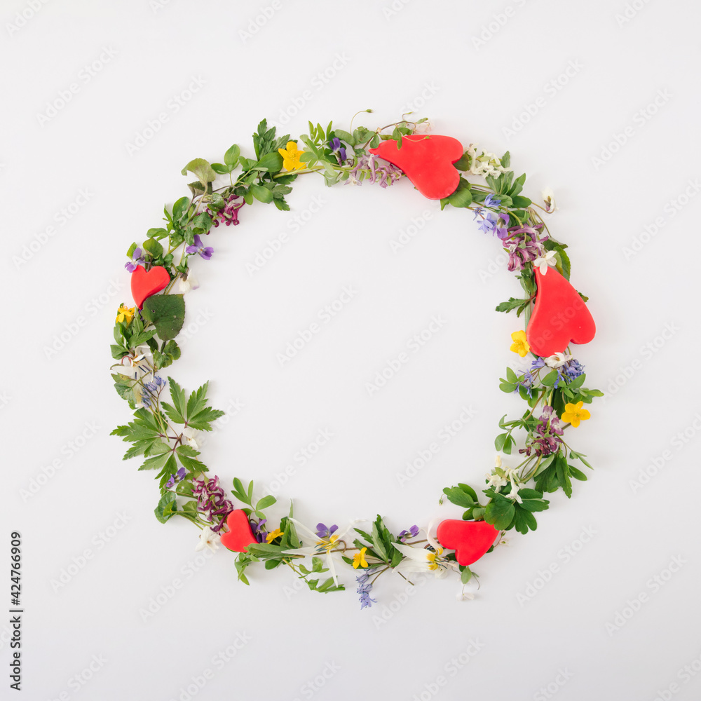 Sring creative circle with flower bloom and red hearts for copy space on the white background. Minimal flat lay composition.