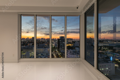 Interior Wall to Wall Window overlooking Sunset twilight cityscape Miami Florida © Monteleone
