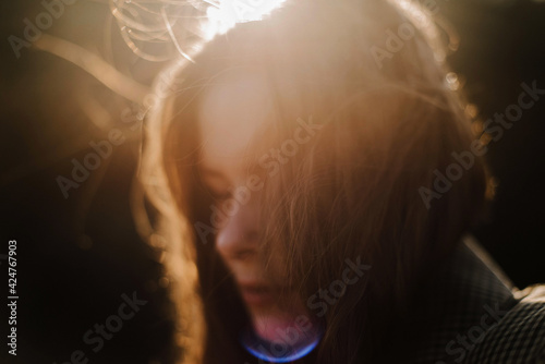 Beautiful portrait of a young stylish woman on a sunny day in autumn.