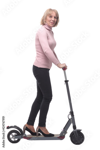 Beautiful woman riding an electric scooter isolated on white background