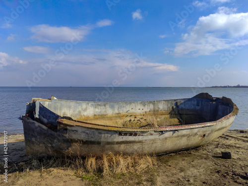 Old boat on the beach in sunny weather