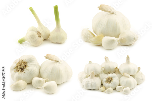 Dried garlic bulbs and some cloves on a white background