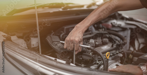 Auto mechanic working and repair on car engine in mechanics garage. Car service. © David