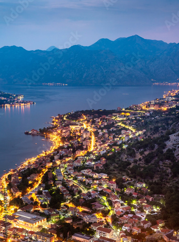 Kotor Bay and Old Town illumiinated at dusk seen from St John's Fortress and hilltop,Montenegro,Eastern Europe. © Neil